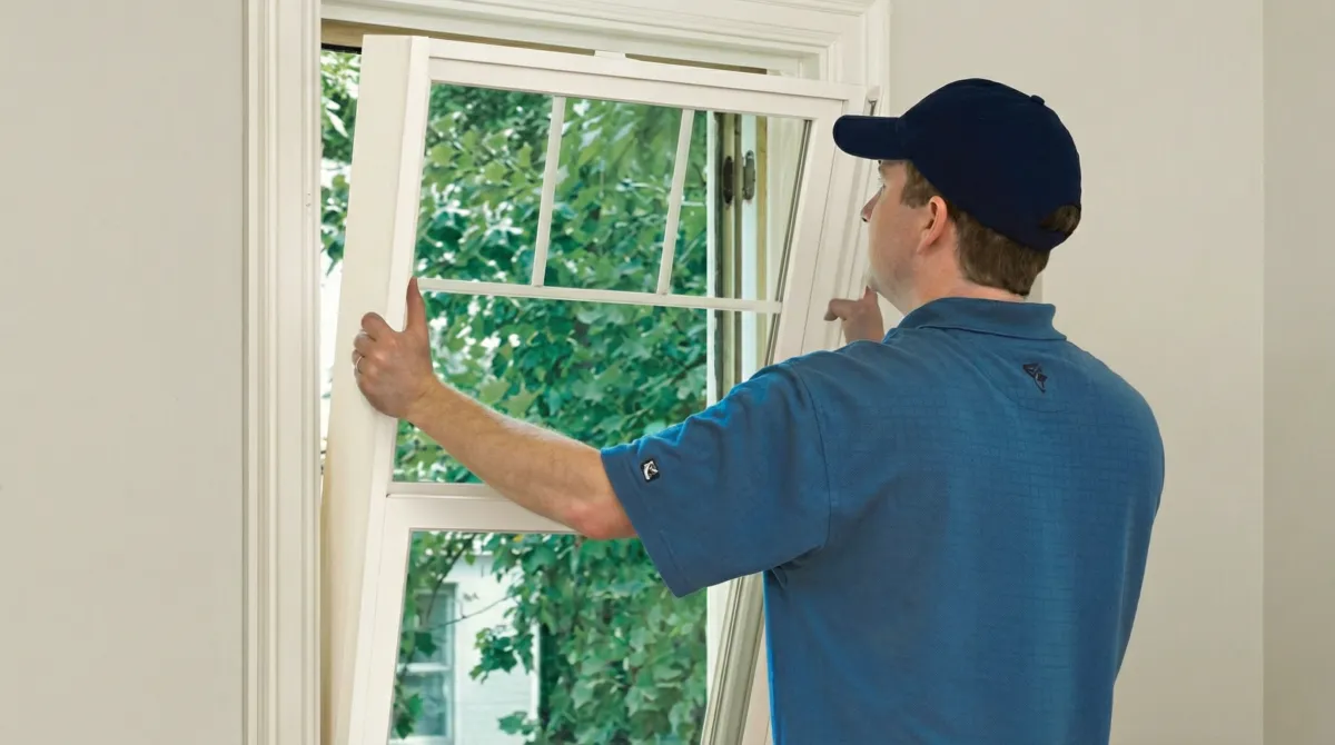 Professional contractors performing a residential window insulation and replacement service in Mobile, AL